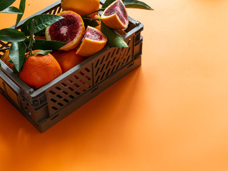 Box with red oranges. Fruit banner. Harvest, abundance, juicy. Copy spaceの写真素材