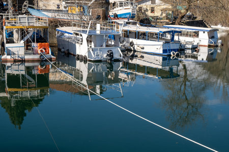 Boats on the calm water of the lake - about February 2023, Virpazar, Montenegroのeditorial素材
