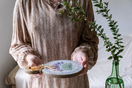 Decorative board in the hands of a young womanの写真素材