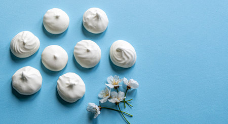 A blue table with a bunch of meringue on itの写真素材