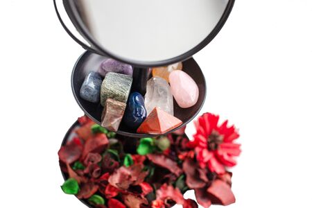 many healing magical stones on a grain support of a mirror close-up.の写真素材