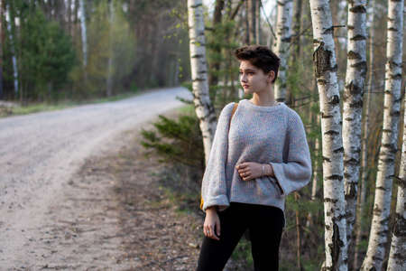 Portrait of a beautiful teenage girl in nature. Short dark hair and tanned skin. The concept of...