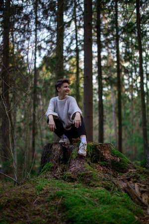 The teenage girl smiles and stops to rest. The concept of walking alone and walking in the fresh air.の写真素材