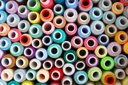 Colored sewing threads, a bunch of bright skeins of thread, close-up. Coils of thread of different...