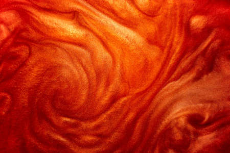 Defocus. Detailed particles of red luster flow with small depth of field under water. Magical shimmering luxurious background. Unfocused. Abstract image.の写真素材