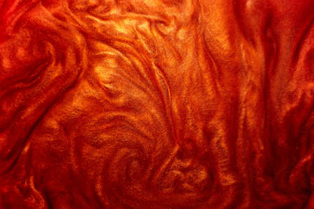 Defocus. Festive magical shimmering underwater luxury background. Abstract elegant, detailed particles of red glitter flow with small depth of field underwater. Festive sparks and lights.の写真素材