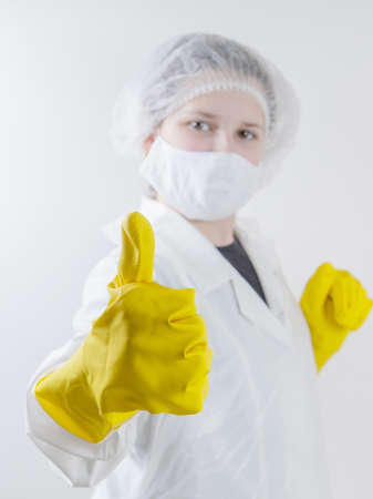 girl in a dressing gown and mask of self-isolationの写真素材