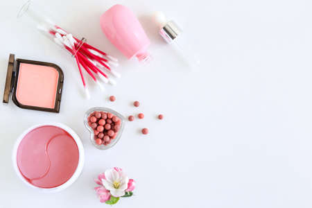 patches, skin care serum, pink blush lie on the white surface on the left, top viewの写真素材