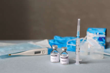 vials of coronavirus vaccine, medical supplies on a blue surface, covid-19 vaccination, medical...