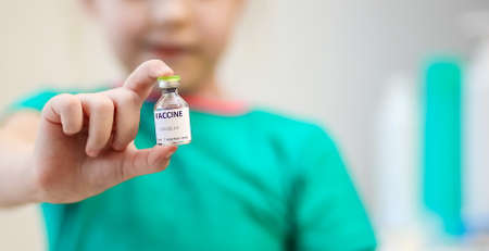Close-up view of the vaccine in the child's hand, vaccination against covid-19, medical conceptの写真素材