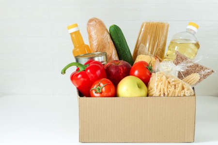 food supply, food delivery by a volotner from the market, a coronavirus pandemic, a food box with...