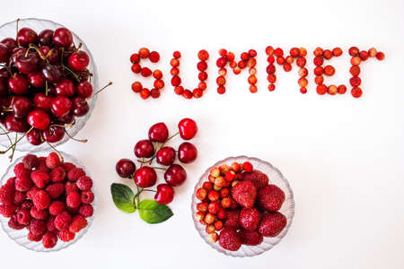 many different red berries on the table, top viewの写真素材