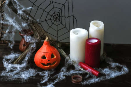 Funny Halloween pumpkin head with candles, cobwebs, bats. Halloween decor with cute pumpkin and...