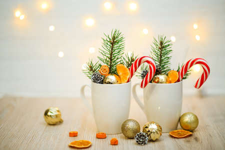 cups with decor on a white wooden background, Christmas and new year conceptの写真素材