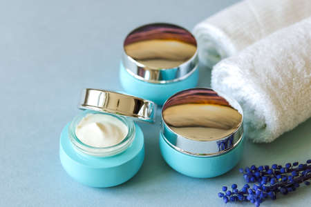 Cosmetic cream in blue glass jars. Natural spa cosmetics.