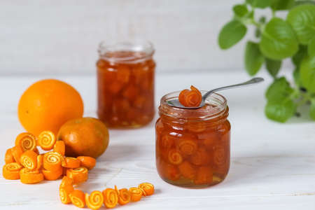 Jars of orange peel jam with curls on a light background. Homemade orange jelly. Step 7. Step by step instructionsの写真素材
