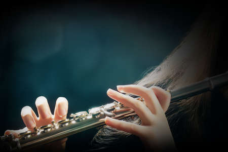 Flute playing flutist musician performer with bright musical instrumentの写真素材