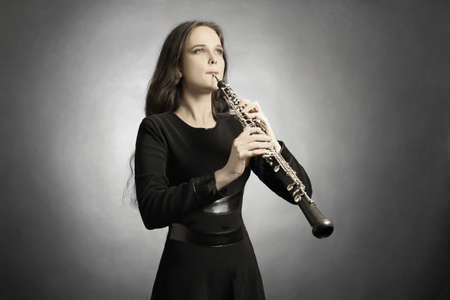 Classical musician oboe playing. Oboist with musical instrument
