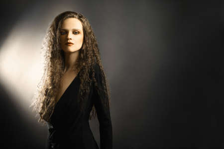 Beautiful woman. Fashion portrait of young curly modelの写真素材