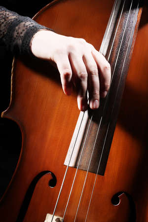 Cello playing cellist hand closeup orchestra instrumentsの写真素材