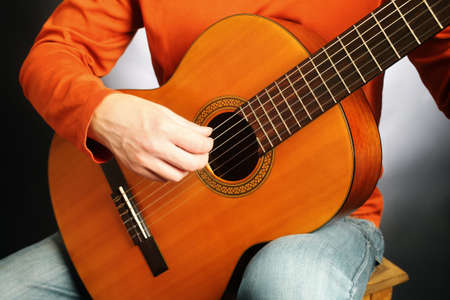 Acoustic guitar playing classical guitarist hands close up