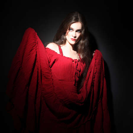 Woman in red dress  Sexy model portrait in darkness  Lady in red
