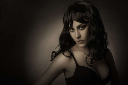 Dark portrait of sensual woman brunette  Black hair model in darkness