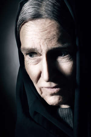 Old woman wrinkled face  Sad senior woman close up portrait with wrinkles