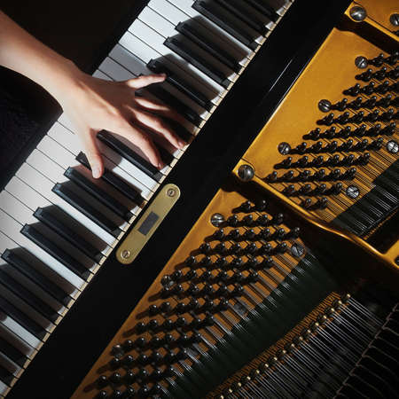 Grand piano closeup pianist hands playingの写真素材