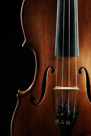 Violin orchestra musical instruments close up on blackの写真素材