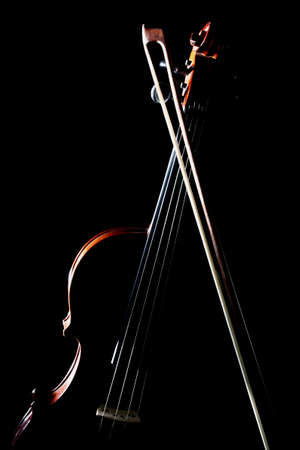 Violin bow orchestra musical instruments isolated on blackの写真素材