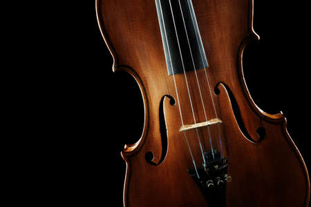 Violin orchestra musical instruments closeup on blackの写真素材