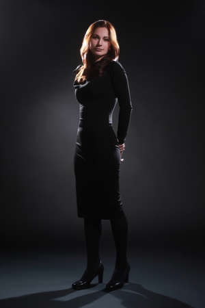 Fashion model in black dress elegant woman full length portraitの写真素材