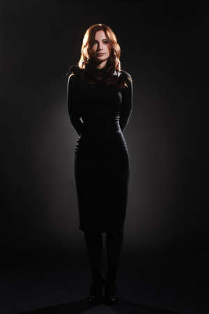 Fashion model in black dress elegant woman full length portraitの写真素材