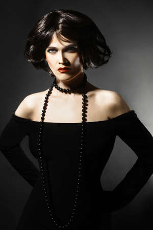Brunette woman Sexy fashion model in black portraitの写真素材