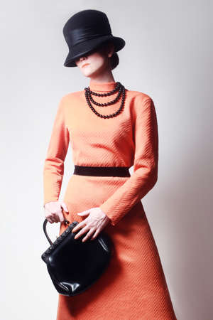 Fashion model Elegant woman Stylish in orange dress and hat