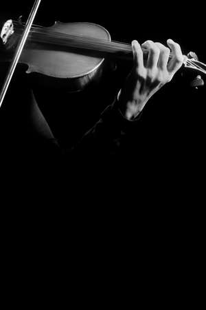 Violin player Violinist hands playing violin closeup on black Musical instruments close upの写真素材