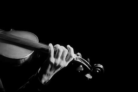 Violin player violinist hands playing musical instruments isolated on blackの写真素材