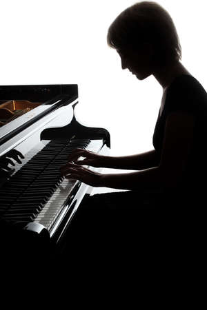 Grand piano player. Pianist woman playing piano Classical musician isolated on whiteの写真素材
