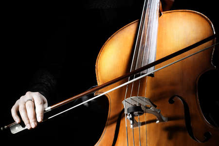 Cello player Cellist hands playing cello with bow orchestra musical instrumentsの写真素材