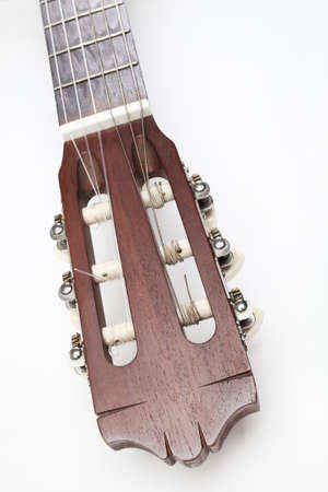 Acoustic guitar classical guitar head neck close up on white background. Musical instruments closeup