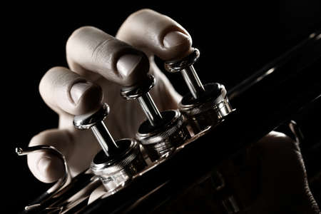 Trumpet player. Trumpeter hands playing brass musical instrument close up