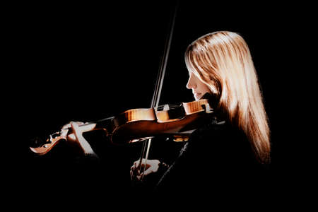 Violin player Violinist playing violin classical musician isolated on blackの写真素材
