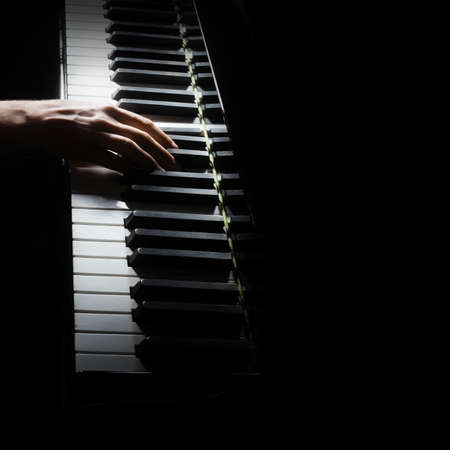 Piano player. Pianist hands piano grand music instrument close up keyboardの写真素材