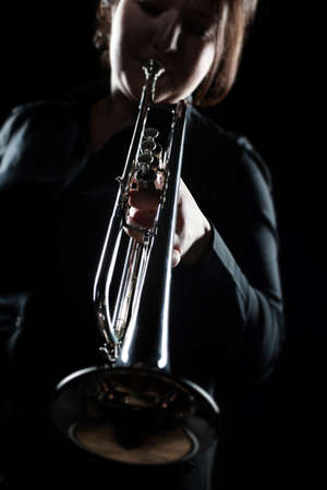Trumpet player. Woman playing jazz Trumpeter with brass instrumentの写真素材