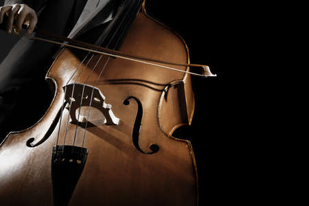 Double bass player Hands playing contrabass musical instrument. Strings cello with bowの写真素材