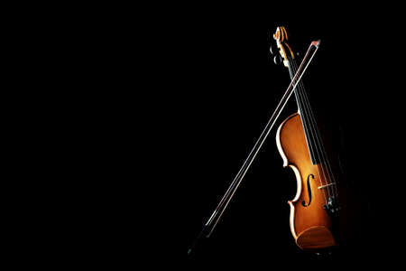 Violin isolated on black. Classical music instruments of orchestra Violin with bowの写真素材
