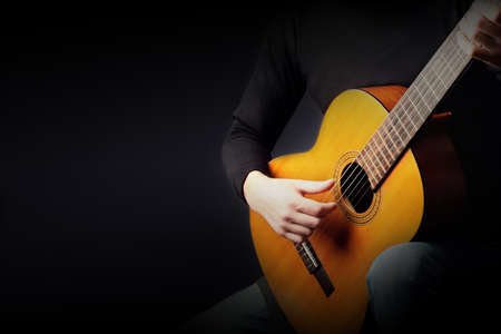 Acoustic guitar player. Classical guitarist playing guitar classic music instrument closeup handsの写真素材
