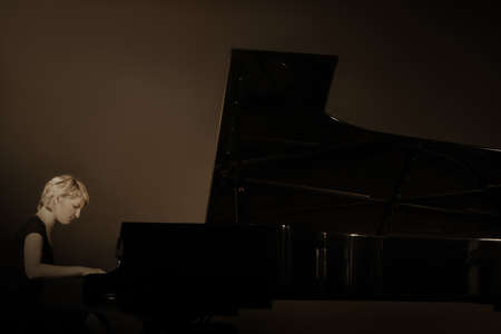 Grand piano player. Pianist concert playing. Piano concert