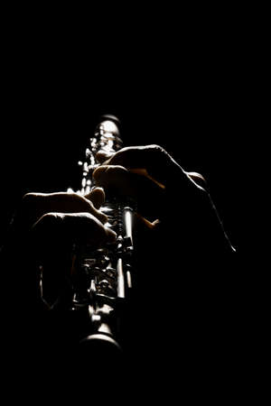 Oboe woodwind instruments. Hands playing classical music orchestra instrument isolated on blackの写真素材